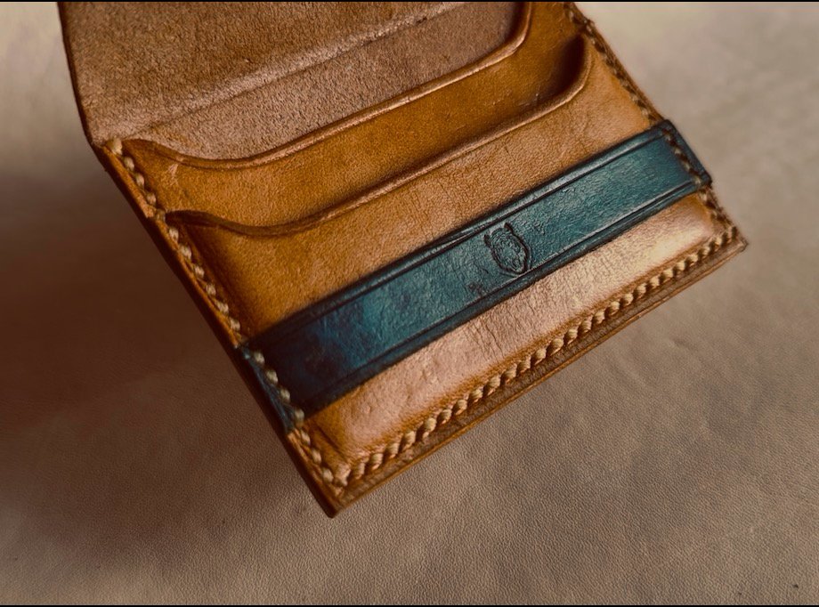 Hand-stitched BURGIS card wallet in tan leather with a teal strap